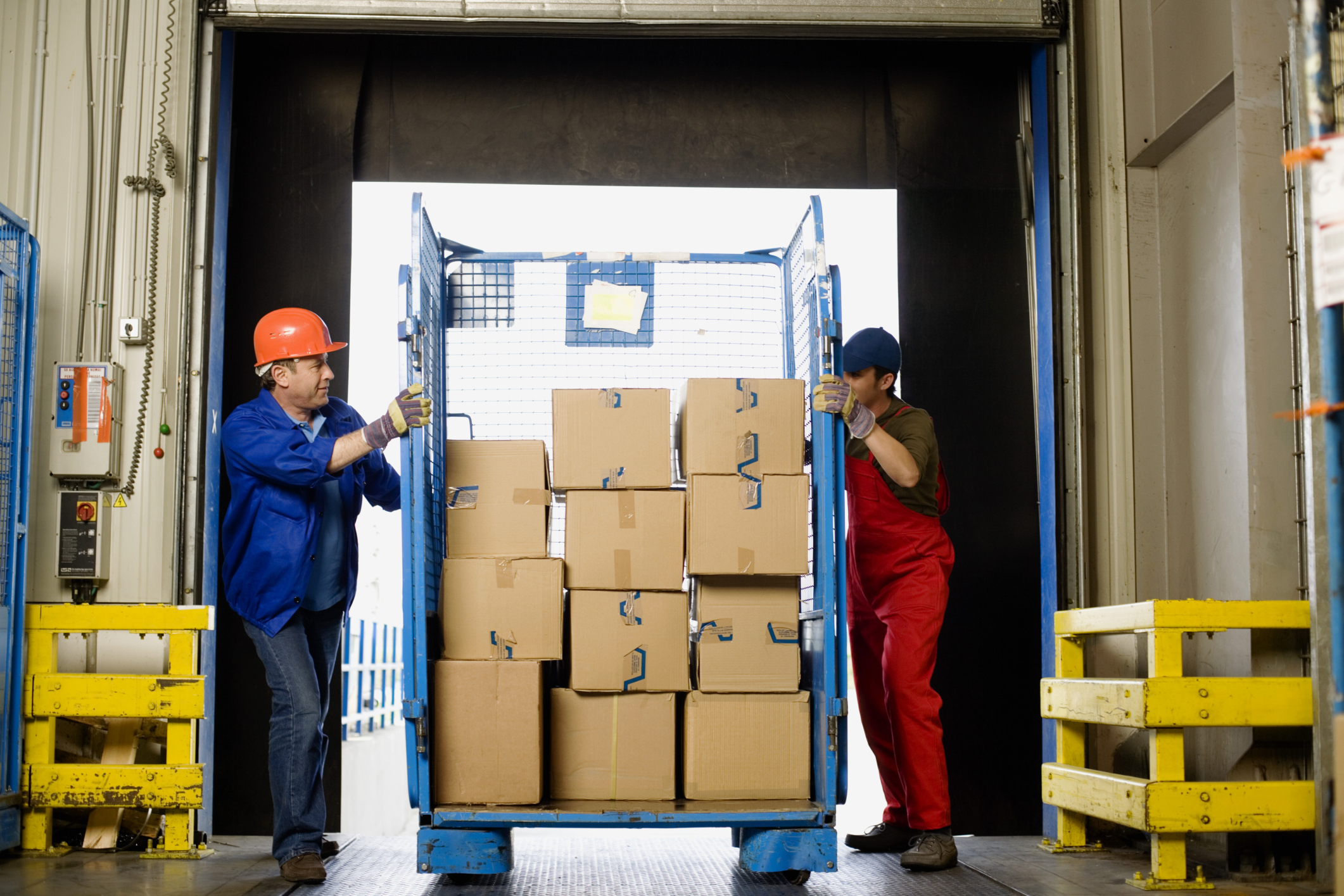 Workers moving boxes in warehouse